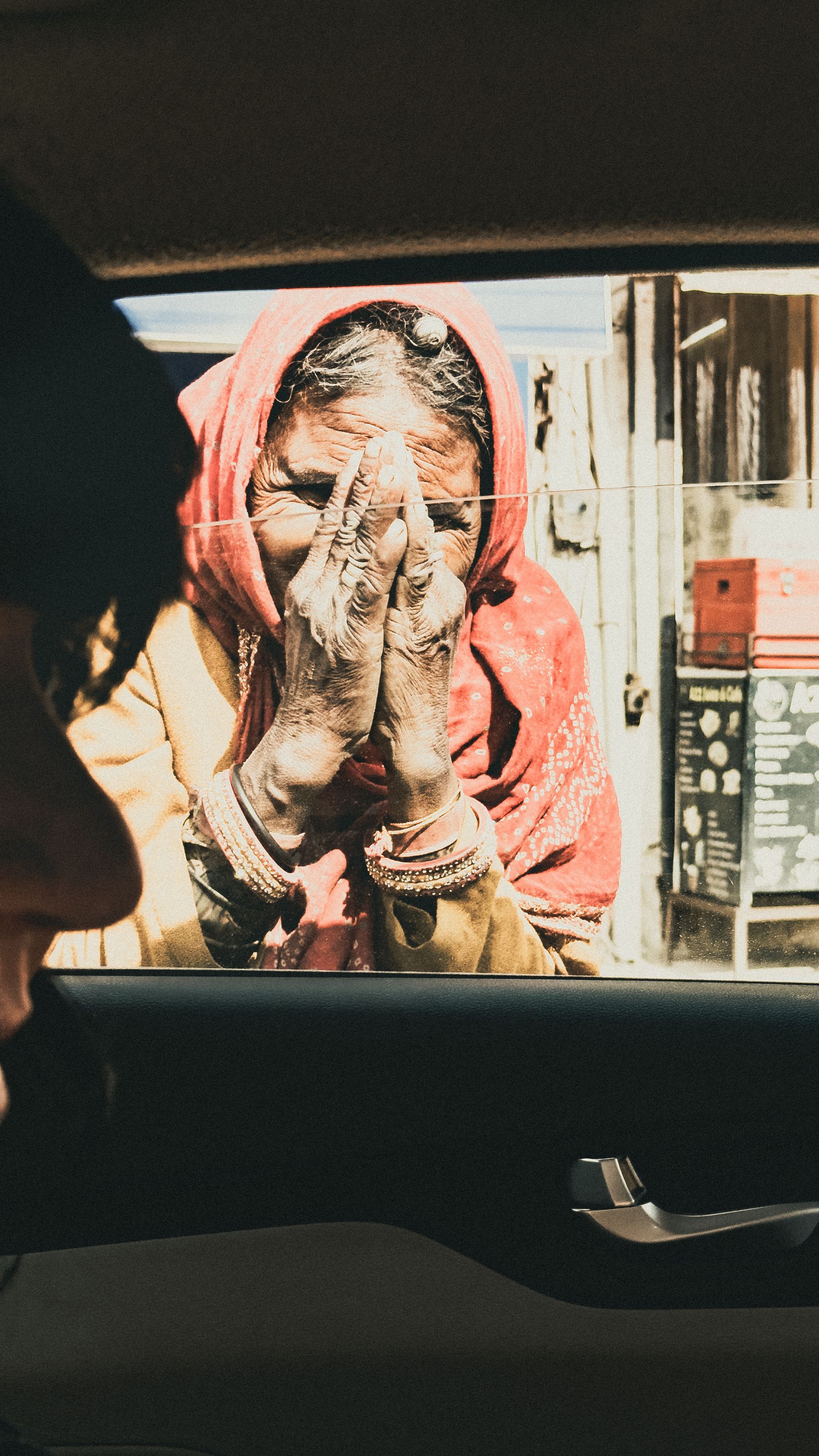 Begging Woman Seen Through Vehicle Window